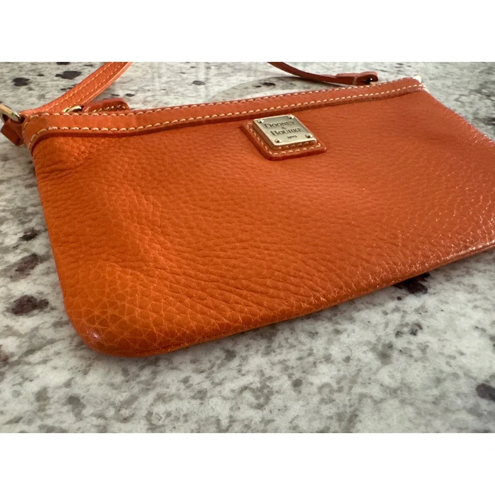 Dooney & Bourke pebble grain large slim wristlet bag in orange